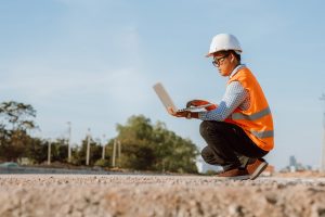 Civil,Engineer,At,Construction,Site,Using,Computer,Laptop,Checking,Work.